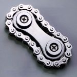 Nahaufnahme einer metallischen Radkette mit Schrauben, geeignet als technisches Dekorationsstück oder wissenschaftliches Gadget.