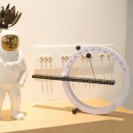 Modernes wissenschaftliches Dekorationsobjekt mit Kalender, Uhr und Astronautenfigur, ideal für wissenschaftliche oder technische Themen.