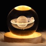 Dekoratives Glas mit einer in der Flüssigkeit schwebenden Planetenskulptur, ideal für wissenschaftliche Dekorationen und moderne Raumgestaltung.