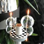 Elegante Kerzen im Glas mit reflektierenden Oberflächen, ideal für wissenschaftliche Dekorationen und Gadgets, schafft eine gemütliche Atmosphäre.