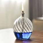 Elegantes Glas-Feuerzeug mit spiralförmigem Design, das Flamme erzeugt, ideal für Dekoration und wissenschaftliche Präsentationen.