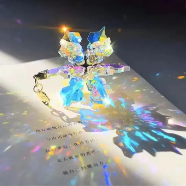 Glitzernder Kristallanhänger in Sternform, der Licht in bunten Reflexen auf Papier projiziert.