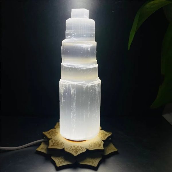 Leuchtende Salzlampe in Form einer mehrstufigen Säule, die warmes Licht ausstrahlt und eine entspannte Atmosphäre schafft.