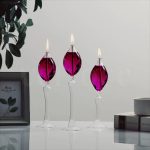 Elegante Kerzenleuchter mit drei Kristallkerzen in Violett, ideal für stilvolle Dekorationen und wissenschaftliche Themen.