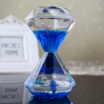 Dekorative Sanduhr mit blauer Flüssigkeit und Meerjungfrau-Figur, ideal als wissenschaftliches Geschenk oder Raumdekoration.