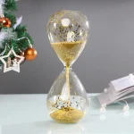 Sanduhr mit goldenen Glitzerpartikeln, die in einem transparenten Gehäuse eine elegante und wissenschaftliche Dekoration darstellen.