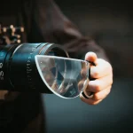 Nahaufnahme einer Hand, die eine wissenschaftliche Brille mit integriertem Teleskop hält, ideal für wissenschaftliche Experimente und Dekorationen.
