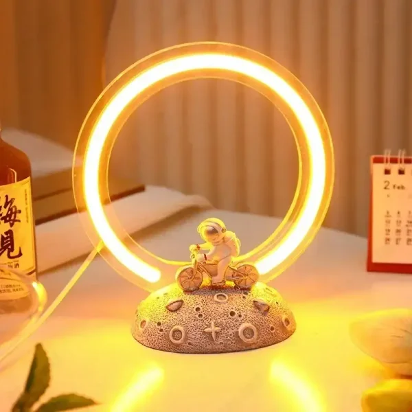 Helles Neonlicht in Form eines Kreises mit kleiner Figur auf einer Basis, ideal für wissenschaftliche Dekorationen und moderne Raumgestaltung.