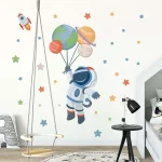 Charmante Wanddekoration mit Astronaut, der mit Planeten und Rakete schwebt, perfekt für Kinderzimmer oder Wissenschaftsraum.