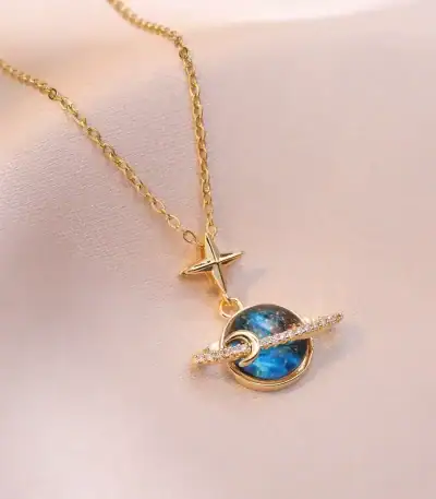 Elegante Halskette mit Stern- und Planetenanhänger, goldfarbenes Design mit funkelnden Details, ideal für Science- und Astronomie-Liebhaber.