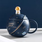 Kaffeetasse im Weltraum-Design mit Astronauten- und Planetenmotiven, ideal für Science-Fans und Dekoration.