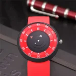 Innovative Schwerkraft-Uhr mit rot-weißem Zifferblatt und beweglichen Zeigern, modernes Design für Wissenschafts- und Technikliebhaber.