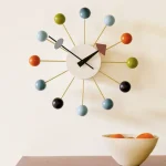 Moderne Wanduhr mit bunten Kugeln als Ziffernblatt, stilvolles Design für Wohnräume.