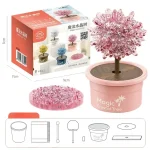 Dekorativer Kristallbaum in rosa Blumentopf, ideal für wissenschaftliche und dekorative Zwecke, mit Verpackung und Zubehör im Hintergrund.
