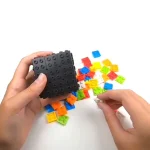 Bunte Bausteine und ein schwarzer Steinbaukasten, ideal für kreative Wissenschafts- und Dekorationsprojekte.