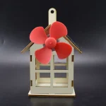 Miniaturhaus mit roten Windrad und Dach aus Holz, dekoratives wissenschaftliches Modell für Zuhause oder Büro.